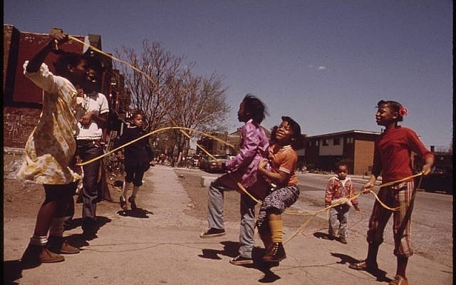 Girls playing double Dutch outside The Ida B. Wells Homes in Chicago, 1973. Photo by John H. White. Wikipedia.