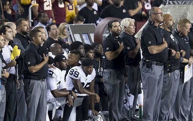 Illustrative. Oakland Raiders players 'take a knee' during the National Anthem, in protest of statements by US President Donald Trump, during week 3 of the 2017 NFL season, on September 24, 2017. (Wikipedia)