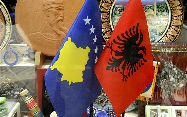 Kosovar and Albanian flags on display in a storefront window in Prizen, Kosovo. (Larry Luxner)