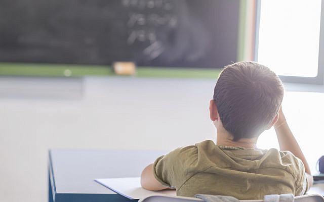 Illustrative. Boy sitting in school classroom. (iStock)