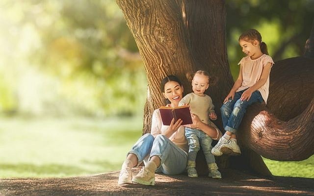 Illustrative. Mother reading to children. (iStock)