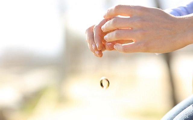 Illustrative. A woman tosses her wedding ring. (iStock)