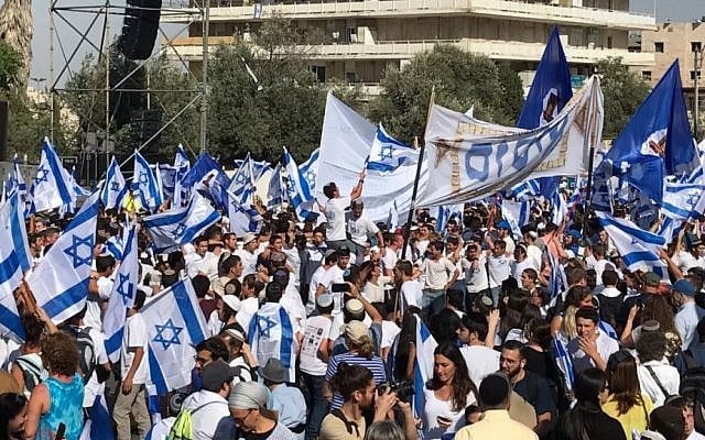 Illustrative. Hundreds of revelers wave Israeli flags as they they prepare to march their way through the city towards the Western Wall for Jerusalem Day. (Like Tress/Times of Israel) Illustrative. Hundreds of revelers wave Israeli flags as they they prepare to march their way through the city towards the Western Wall for Jerusalem Day. (Like Tress/Times of Israel)