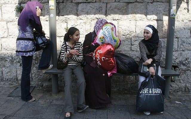 A young girl sits with balloons with other muslim women at a bus stop in East Jerusalem. October 02, 2008. (Lara Savage/Flash90) A young girl sits with balloons with other muslim women at a bus stop in East Jerusalem. October 02, 2008. (Lara Savage/Flash90)