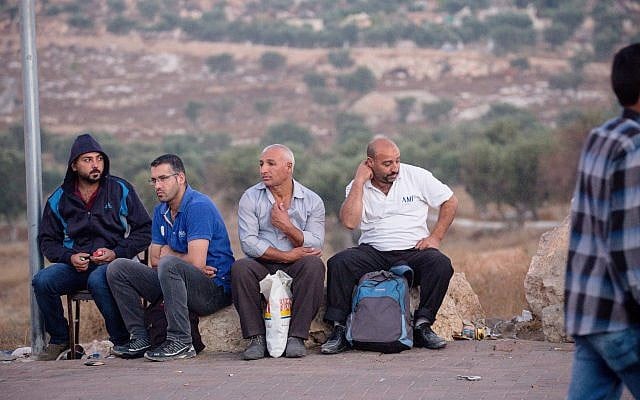 Palestinian men waiting by the side of the road near Checkpoint 300 in Bethlehem, minutes from Jerusalem. (Laura Ben-David)