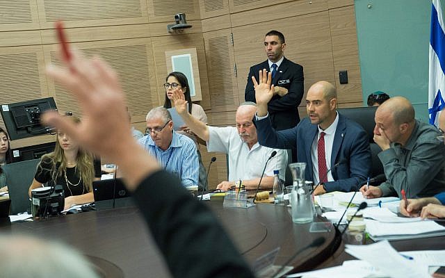 Illustrative: Committee Chairman Amir Ohana and Jewish Home parliament members Nissam Slomiansky vote at the joint Knesset and Constitution Committee meeting discussing the proposed National Law, at the Knesset, on July 17, 2018. (Yonatan Sindel/Flash90) Illustrative: Committee Chairman Amir Ohana and Jewish Home parliament members Nissam Slomiansky vote at the joint Knesset and Constitution Committee meeting discussing the proposed National Law, at the Knesset, on July 17, 2018. (Yonatan Sindel/Flash90)