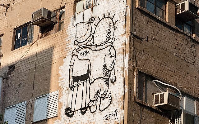 The Peace Kids, a mural affiliated with Meretz in Tel Aviv, on Ha-Rav Yitskhak Yedidya Frenkel Street, depicting Palestinian Handala and Israeli Srulik embracing one another, on October 12, 2014. The drawing illustrates friendship between Jews and Arabs: on the left, 'Srulik,' a cartoon character symbolizing Israel, and on the right, Handala, a cartoon character by Naji Al-Ali, a 10-year-old barefoot boy, which has become a powerful symbol for Palestinians. (Wikipedia) The Peace Kids, a mural affiliated with Meretz in Tel Aviv, on Ha-Rav Yitskhak Yedidya Frenkel Street, depicting Palestinian Handala and Israeli Srulik embracing one another, on October 12, 2014. The drawing illustrates friendship between Jews and Arabs: on the left, 'Srulik,' a cartoon character symbolizing Israel, and on the right, Handala, a cartoon character by Naji Al-Ali, a 10-year-old barefoot boy, which has become a powerful symbol for Palestinians. (Wikipedia)