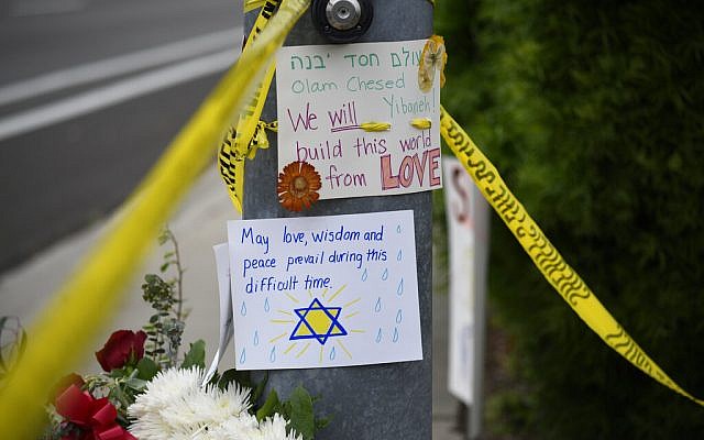 Flowers and signs sit at a memorial across the street from the Chabad of Poway synagogue, on Sunday, April 28, 2019, in Poway, California. A man opened fire Saturday, inside the synagogue near San Diego, as worshipers celebrated the last day of Passover. (AP Photo/ Denis Poroy) Flowers and signs sit at a memorial across the street from the Chabad of Poway synagogue, on Sunday, April 28, 2019, in Poway, California. A man opened fire Saturday, inside the synagogue near San Diego, as worshipers celebrated the last day of Passover. (AP Photo/ Denis Poroy)