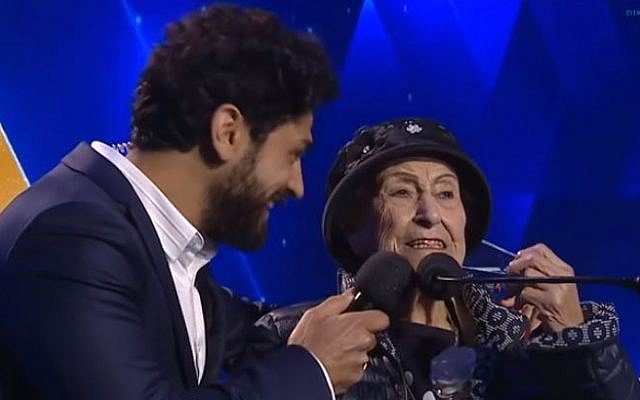Illustrative. Host Aviv Alush, left, and torch-lighter Marie Nahmias, 93, at Israel's 71st Independence Day ceremony in Jerusalem, May 8, 2019. (Kan screen capture)