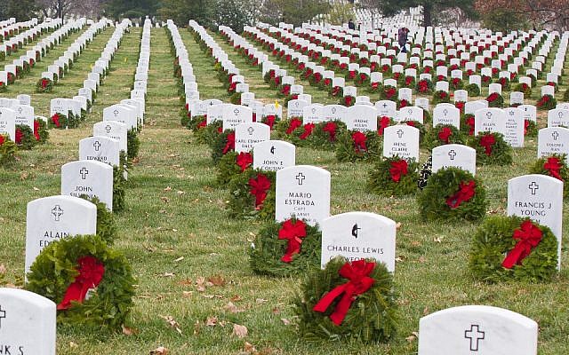 Volunteers with Wreaths Across America placed more than 100,000 remembrance wreaths on headstones of fallen soldiers of many religions, at Arlington National Cemetery, Virginia., December 13, 2013, including. (US Army photo by Spc. James K. McCann/Released, via Wikipedia)