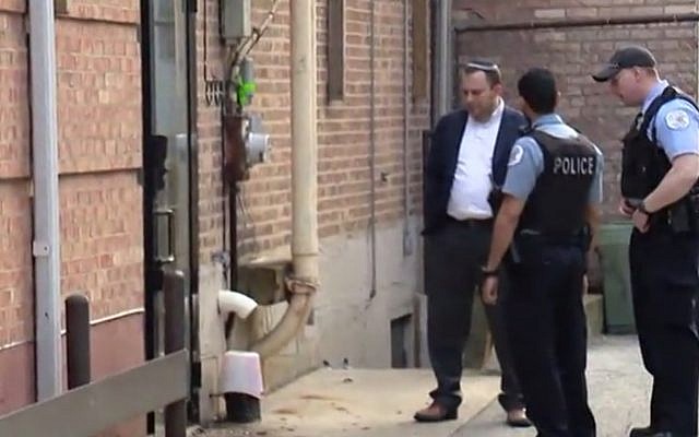 Police and Rabbi David Wolkenfeld investigating suspected arson outside Anshei Sholom B'nei Israel synagogue in Chicago on May 19, 2019. (screen capture: Fox32 Chicago, via The Times of Israel) Police and Rabbi David Wolkenfeld investigating suspected arson outside Anshei Sholom B'nei Israel synagogue in Chicago on May 19, 2019. (screen capture: Fox32 Chicago, via The Times of Israel)