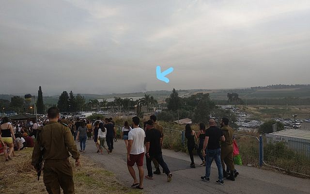 Smoke and fire are visible in the distance as we are leaving the ceremony. (courtesy)