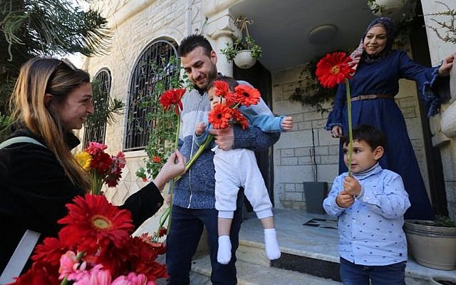 After Arab residents of the French Hill neighborhood in Jerusalem had their cars vandalized, the Tag Meir Hebrew University chapter showed up in the neighborhood to hand out flowers to the Arab residents and then joined them in a solidarity protest. April, 2015 (Photo Credit: Yossi Zamir) After Arab residents of the French Hill neighborhood in Jerusalem had their cars vandalized, the Tag Meir Hebrew University chapter showed up in the neighborhood to hand out flowers to the Arab residents and then joined them in a solidarity protest. April, 2015 (Photo Credit: Yossi Zamir)