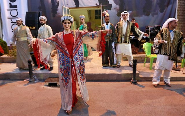 Dancers wearing traditional Iraqi folk costume perform during World Refugee Day in Baghdad, Iraq, Thursday, June 20, 2019. (AP Photo/Hadi Mizban)