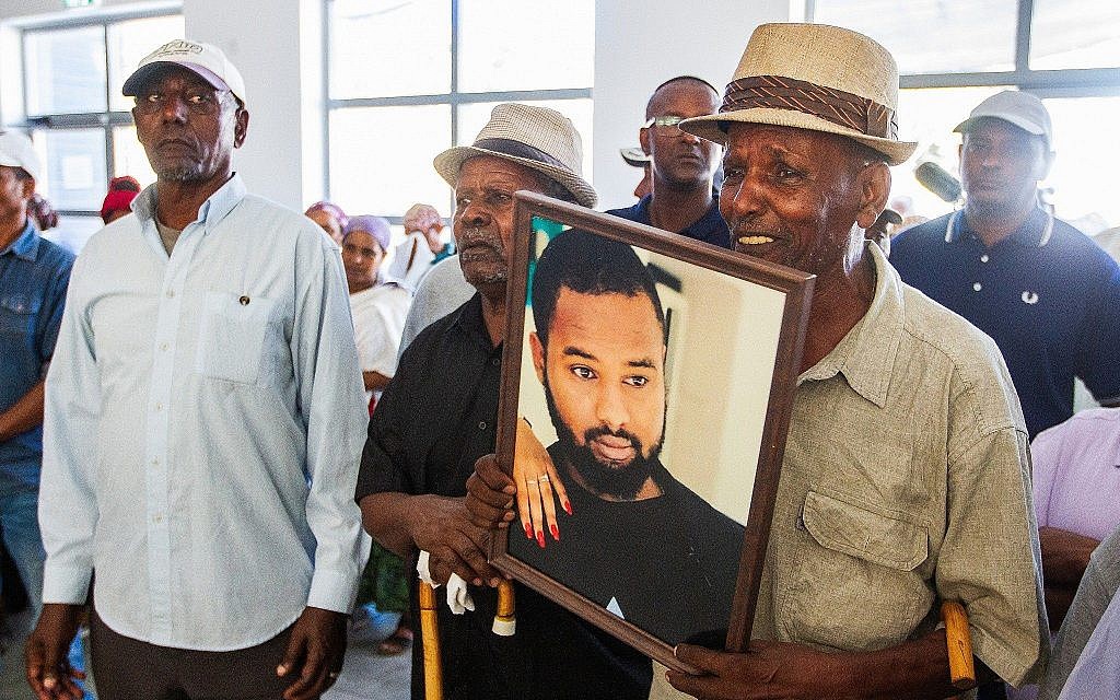 Family and friends mourn at the funeral of Solomon Tekah, in Kiryat Haim, on July 2, 2019. (Yonatan Sindel/Flash90)