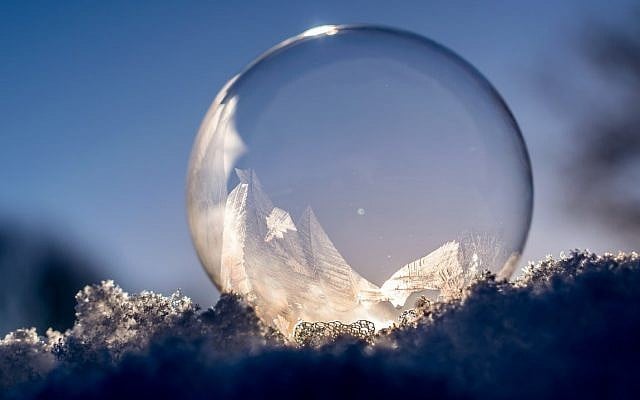 The moon reflected in a frozen bubble. (Public Domain/ PxHere)