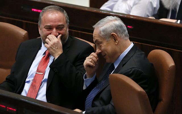 Then-foreign minister Avigdor Liberman seen with Prime Minister Benjamin Netanyahu in the Knesset's plenum hall, as the Knesset votes on the Governance Bill, which, among others, would raise the electoral threshold. March 11, 2014. (Miriam Alster/FLASH90/File) Then-foreign minister Avigdor Liberman seen with Prime Minister Benjamin Netanyahu in the Knesset's plenum hall, as the Knesset votes on the Governance Bill, which, among others, would raise the electoral threshold. March 11, 2014. (Miriam Alster/FLASH90/File)