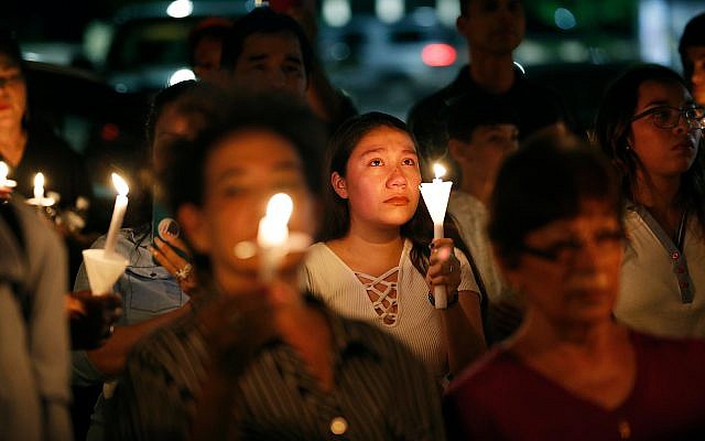 Illustrative. People attend a candlelight vigil for victims of a mass shooting at a shopping complex over the weekend, August 5, 2019, in El Paso, Texas. (AP Photo/John Locher)