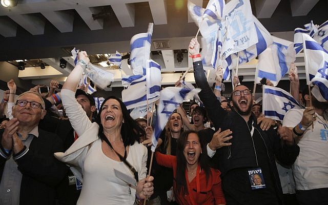 Blue and White part supporters cheer at the party's campaign headquarters after polls for Israel's general elections closed, in Tel Aviv, Tuesday, April 9, 2019. (AP Photo/Sebastian Scheiner via Jewish News)
