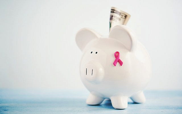 Piggy bank with breast cancer awareness ribbon and cash to portray the concept of fundraising for breast cancer awareness and research. (Catherine Lane/Getty Images)