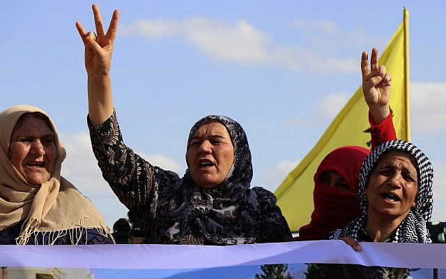 Kurdish women flash victory signs and shout slogans, as they protest against possible Turkish military operation on their areas, at the Syrian-Turkish border, in Ras al-Ayn, Syria, Monday, Oct. 7, 2019. (AP Photo) Kurdish women flash victory signs and shout slogans, as they protest against possible Turkish military operation on their areas, at the Syrian-Turkish border, in Ras al-Ayn, Syria, Monday, Oct. 7, 2019. (AP Photo)