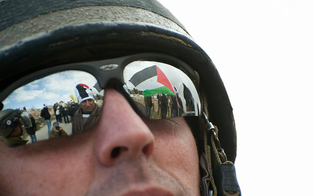 Illustrative: Israeli soldier at a demonstration against the separation barrier in the West Bank town of Al-Masara. January 27, 2012 (iStock)
