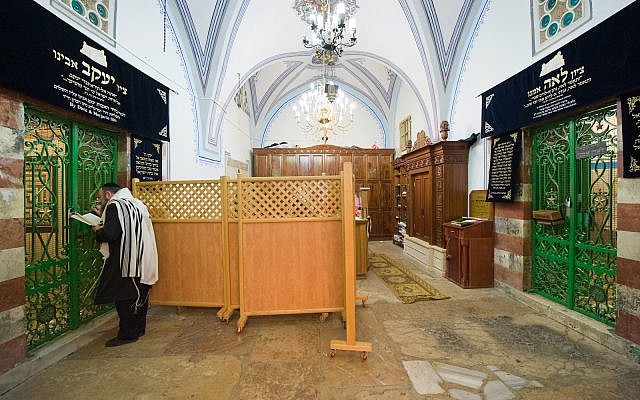 HEBRON, ISRAEL, 10 OCT, 2014: Behind the green iron door on the left is the tomb of patriarch Jacob, on the right his wife Leah. The tombs of the patriarchs are situated in the Cave of Machpelah in Hebron