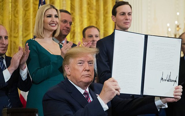 President Donald Trump shows the executive order he signed combating anti-Semitism in the US, during a Hanukkah reception in the East Room of the White House, on December 11, 2019, in Washington. (AP Photo/Manuel Balce Ceneta) President Donald Trump shows the executive order he signed combating anti-Semitism in the US, during a Hanukkah reception in the East Room of the White House, on December 11, 2019, in Washington. (AP Photo/Manuel Balce Ceneta)