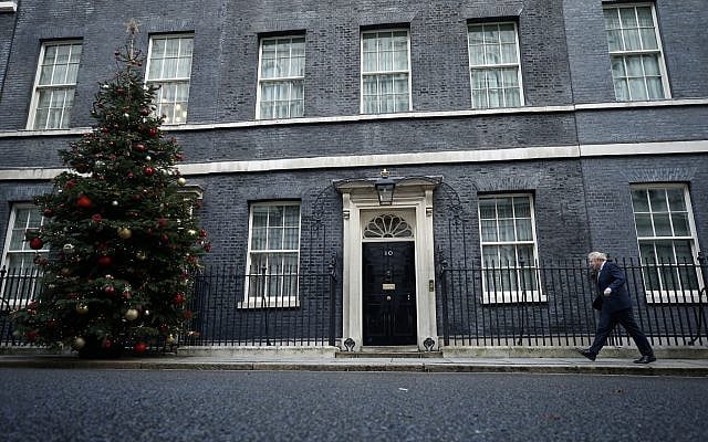 Britain's Prime Minister Boris Johnson returns to 10 Downing Street, on December 13, 2019. Johnson's Conservative Party won a solid majority of seats in Britain's Parliament — a decisive outcome to a Brexit-dominated election that should allow Johnson to fulfill his plan to take the UK out of the European Union next month. (AP Photo/Matt Dunham)