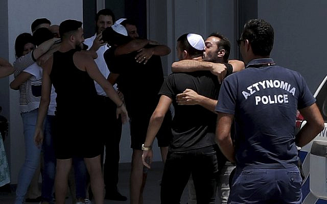 An Israeli teenager is embraced by relatives after being released from Famagusta police headquarters in southeast town of Paralimni, Cyprus, in July 2019. He and 11 other Israelis were accused of raping a British girl, but were let go by the courts in Cyprus. (AP Photo/Petros Karadjias via Jewish News) An Israeli teenager is embraced by relatives after being released from Famagusta police headquarters in southeast town of Paralimni, Cyprus, in July 2019. He and 11 other Israelis were accused of raping a British girl, but were let go by the courts in Cyprus. (AP Photo/Petros Karadjias via Jewish News)