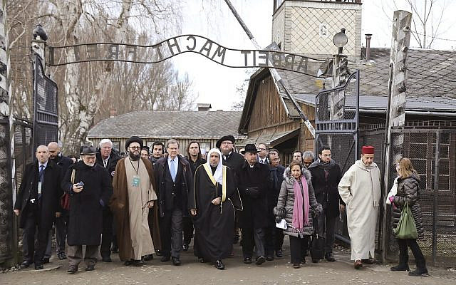 A delegation of Muslim religious leaders at the gate leading to the former Nazi German death camp of Auschwitz, together with a Jewish group in what organizers called “the most senior Islamic leadership delegation" to visit the former Nazi death camp, in Oswiecim, Poland, January 23, 2020. (American Jewish Committee via AP) A delegation of Muslim religious leaders at the gate leading to the former Nazi German death camp of Auschwitz, together with a Jewish group in what organizers called “the most senior Islamic leadership delegation" to visit the former Nazi death camp, in Oswiecim, Poland, January 23, 2020. (American Jewish Committee via AP)
