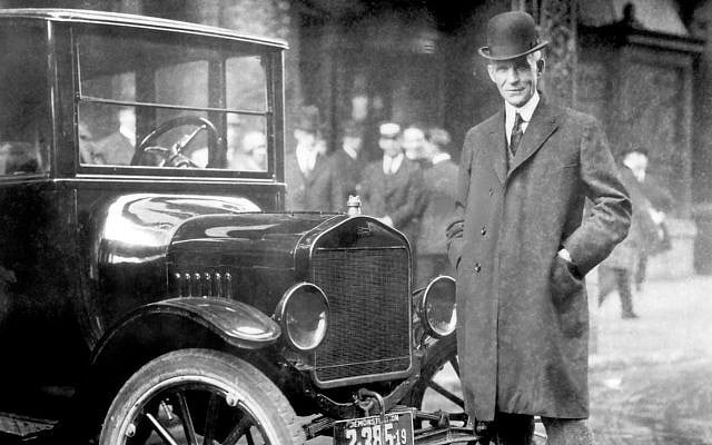 Henry Ford, with 1921 Model T. Ford was at the forefront of spreading the false rumors of a Jewish conspiracy. (Ford Motor Company/Wikimedia)