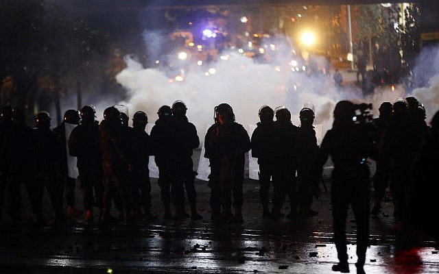 Lebanese riot police fire tear gas towards supporters of the Shiite Hezbollah and Amal groups in Beirut, Lebanon, December 17, 2019. (Bilal Hussein/AP)