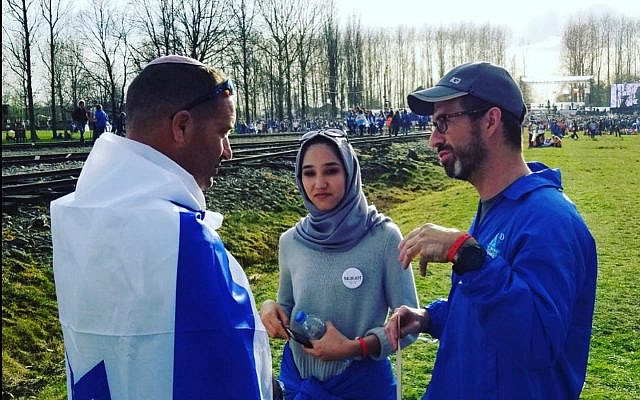 Tuvia talking with a Muslim student and her Catholic teacher from an Austrian high school at Birkenau. Photo (c) T. Book, 2023