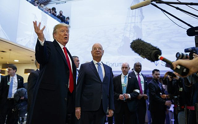 President Donald Trump talks with reporters as he arrives at the World Economic Forum, Friday, Jan. 26, 2018, in Davos. (AP Photo/Evan Vucci)