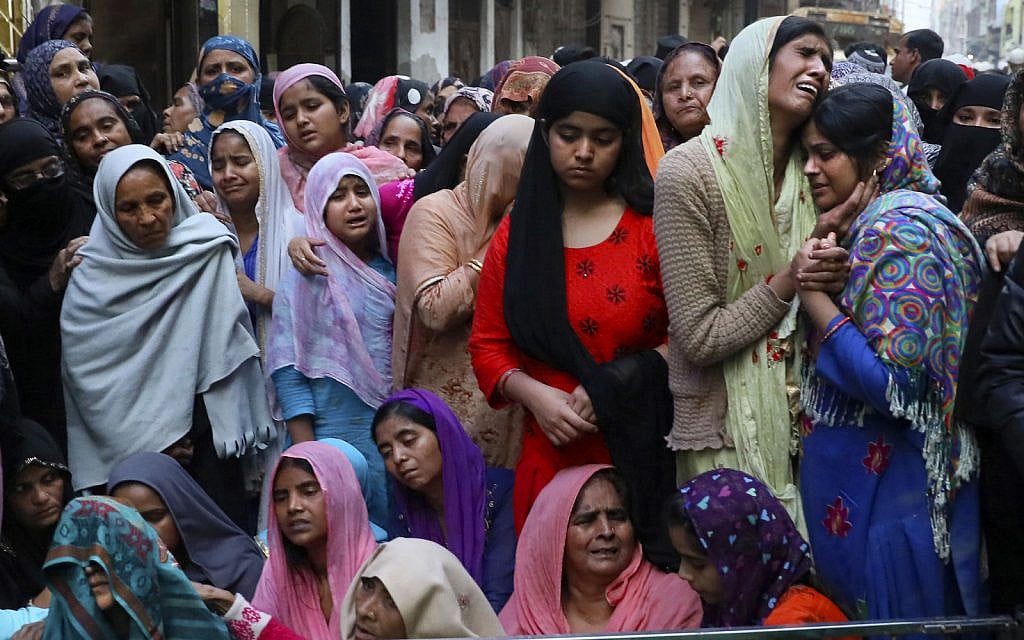 Relatives and neighbors wail near the body of Mohammad Mudasir, 31, who was killed in communal violence in New Delhi, India, Feb. 27, 2020. (AP Photo/Manish Swarup)