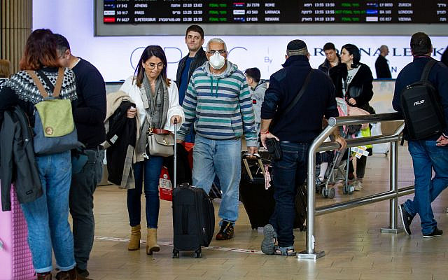 ILLUSTRATIVE -- People wearing face masks for fear of the coronavirus at the Ben Gurion International Airport on February 27, 2020 (Flash90)