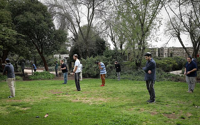 Illustrative. Students pray outside Yeshivat Har Etzion in Alon Shvut, in Gush Etzion, on March 15, 2020, after it was closed as part of measures to prevent the spread of the coronavirus. (Gershon Elinson/Flash90) Illustrative. Students pray outside Yeshivat Har Etzion in Alon Shvut, in Gush Etzion, on March 15, 2020, after it was closed as part of measures to prevent the spread of the coronavirus. (Gershon Elinson/Flash90)