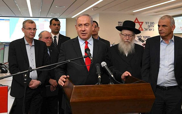 Prime Minister Benjamin Netanyahu, center, visits the Magen David Adom's coronavirus operations center in Jerusalem together with Finance Minister Moshe Kahlon, right, Health Minister Yaakov Litzman, second right, Tourism Minister Yariv Levin, left, and National Security Adviser Meir Ben-Shabbat, second left, on February 27, 2020. (Amos Ben Gershom/GPO)