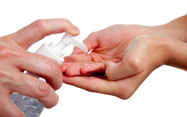 Illustrative. An adult dispensing hand-sanitizer to a child. (iStock)