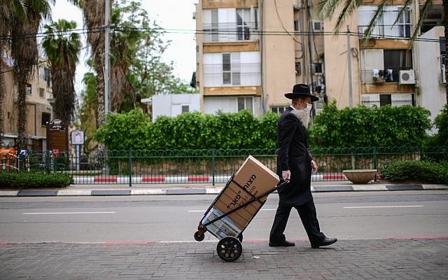 A man walks in Bnei Brak. April 01, 2020. (Tomer Neuberg/Flash90)