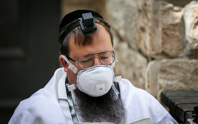 Illustrative: Jewish man prays outside the closed Rashbi gravesite in Meron, Northern Israel, on April 22, 2020. (David Cohen/Flash90) Illustrative: Jewish man prays outside the closed Rashbi gravesite in Meron, Northern Israel, on April 22, 2020. (David Cohen/Flash90)
