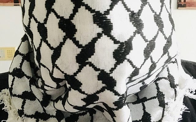 A Palestinian keffiyeh being worn by the author.