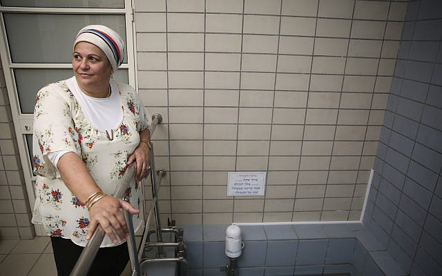 Illustrative. Nora Edri is a 'balanit,' a woman who checks that dipping in the water of the mikveh is done right and is kosher according to the Jewish tradition. These days, the 'balaniot' also wipe down surfaces, and more, in the fight to protect women from the contagious coronavirus. (Hadas Parush/Flash 90)