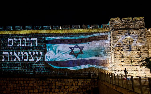 The Israeli flag is screened on the walls of Jerusalem's Old City, as Israel celebrates its 72nd Independence Day under lockdown due to the coronavirus, April 28, 2020. (Yonatan Sindel/Flash90) The Israeli flag is screened on the walls of Jerusalem's Old City, as Israel celebrates its 72nd Independence Day under lockdown due to the coronavirus, April 28, 2020. (Yonatan Sindel/Flash90)