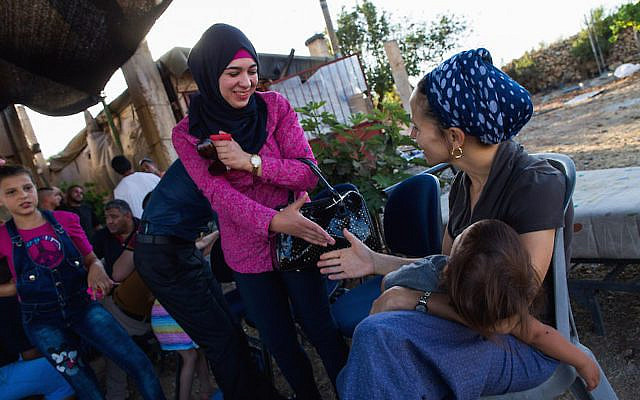 Israeli Jews and Palestinians talk to each other, during a weekly meeting organized by Ali Abu Awwad, a Palestinian from the West Bank, on July 22, 2015. Ali organizes meetings between Jews and Palestinians at his home, to promote cooperation and co-existence. Photo by Nati Shohat/Flash90