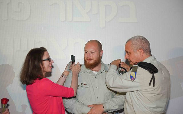 Pinning the rank on Erik together with Brigadier General Yossi Iluk. (courtesy)