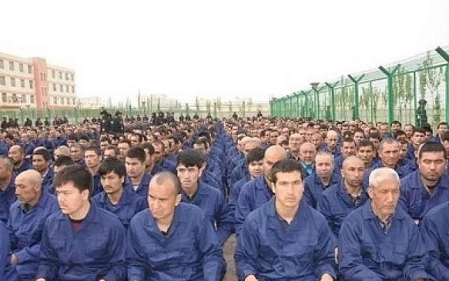 Detainees in a Xinjiang Re-education Camp listening to de-radicalization talks (credit: Wikimedia Commons)