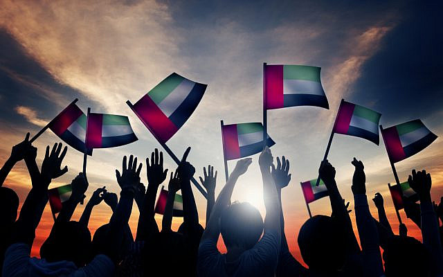 People waving flag of the United Arab Emirates (UAE). (iStock)
