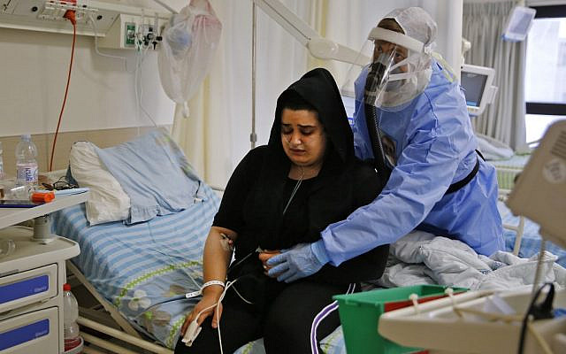 A patient undergoes physiotherapy to help with oxygen circulation at the COVID-19 isolation ward of Meir Medical Center in Kfar Saba on September 9, 2020. (GIL COHEN-MAGEN / AFP)